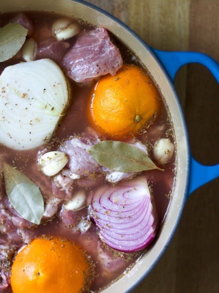 Carnitas for a crowd are made with onions, oranges, limes, and seasonings for tons of flavor.