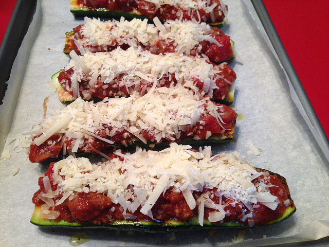 zucchini boats loaded with Nana's spaghetti sauce and parmesan and ready for the oven
