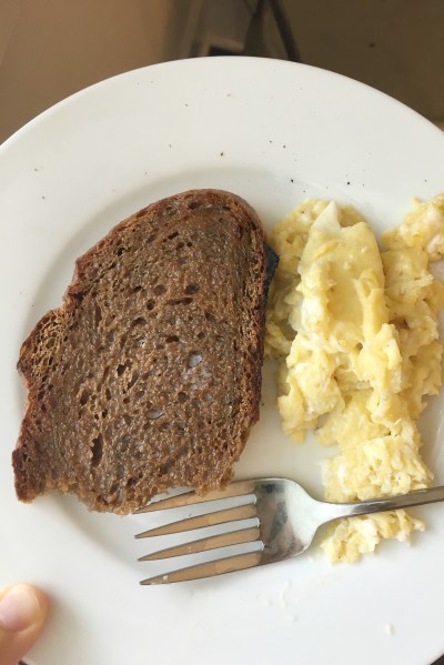 a slice of outback bread with scrambled eggs