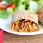 Veggie-packed baked burritos are stuffed with a hearty filling and baked to crispy perfection - and make an awesome freezer meal!