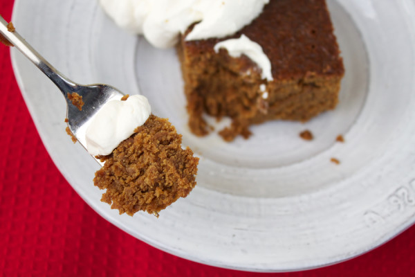 a bite of old-fashioned gingerbread with whipped cream