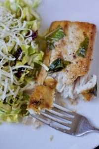 a flaky bite of pan-seared mahi-mahi with a Brussels sprout salad