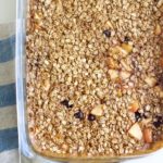 a pan of baked oatmeal with apples and blueberries